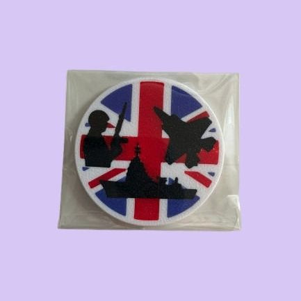 Magnet with silhouettes of a ship, airplane, and person holding a gun on a Union Jack background.