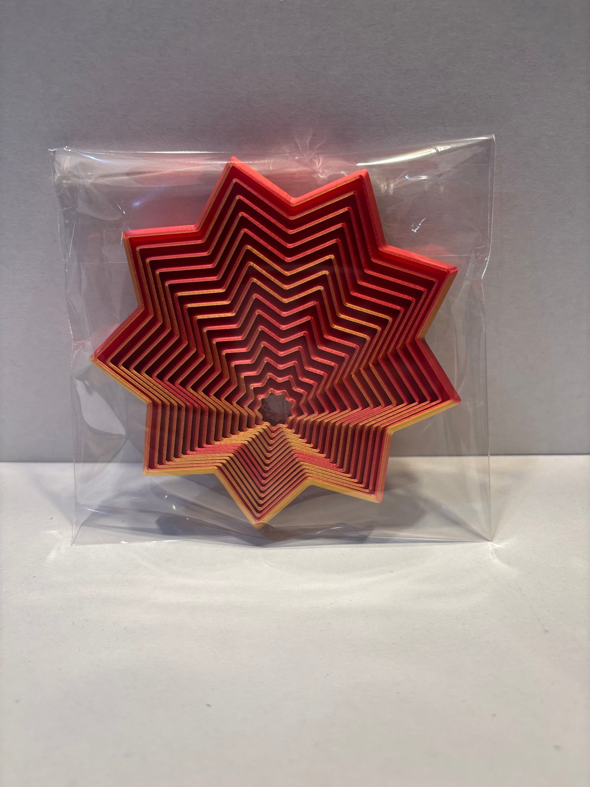 Living Aid - Sensory Star Super Fidget Flat 100mm - Red Gold - Top View Packaged