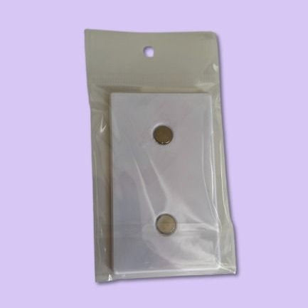 Clear plastic packaging with a white rectangular object on a light purple background
